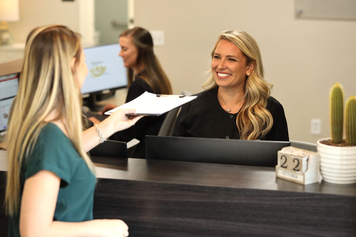 A patient checking in at the Benner & Townsend front desk
